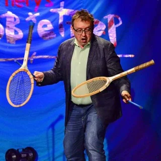 Performer juggling vintage tennis rackets at Scot Nery's Boobietrap