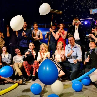 Scot Nery's Boobietrap cast and performers posing with balloons and props on stage
